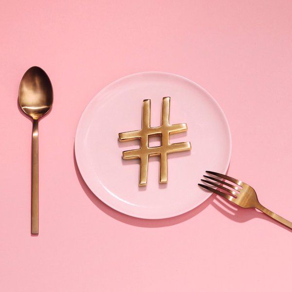 A golden hashtag served on a plate with a fork and spoon