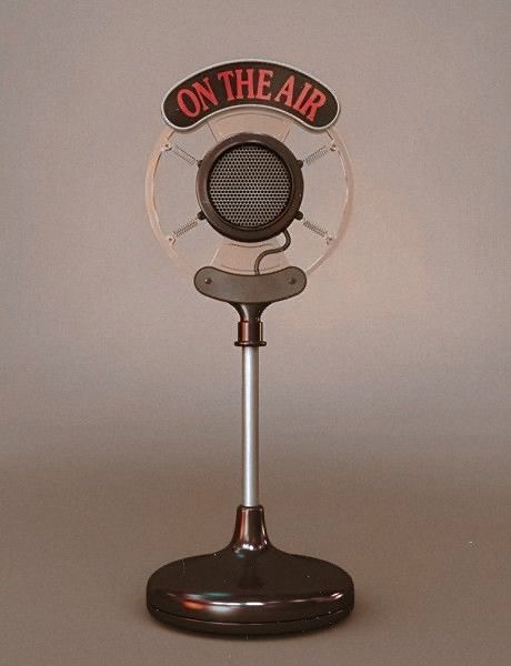 A vintage On The Air microphone on a chrome stand